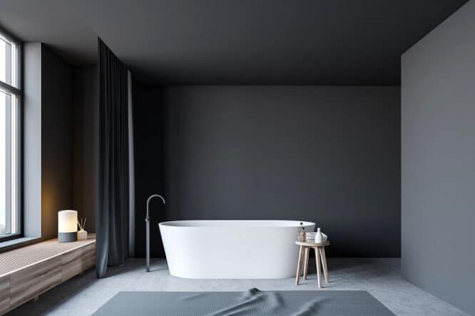 Minimalistisches Bad mit grauen Wänden und Betonboden.